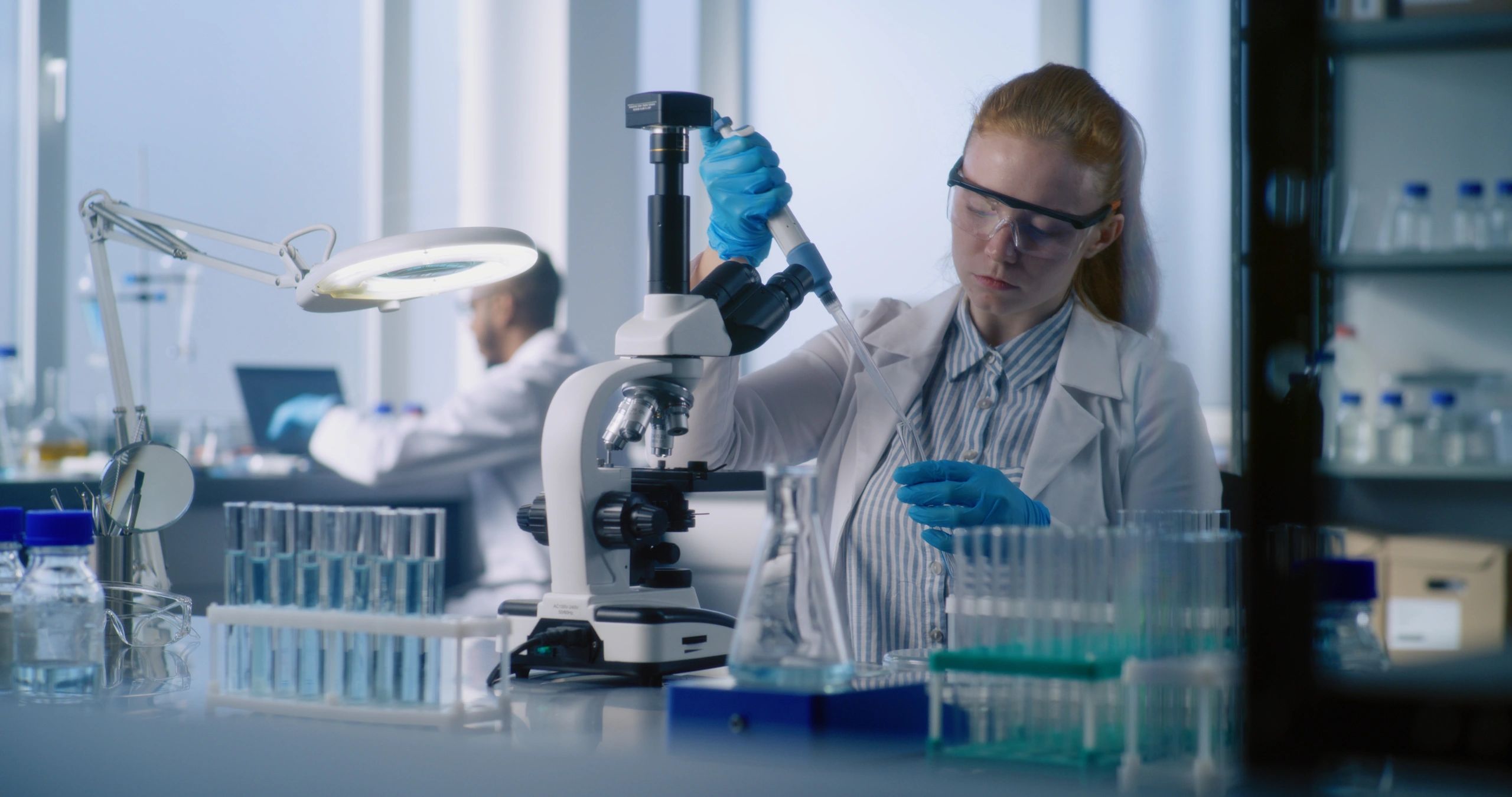 Scientist examining a sample in a bright laboratory